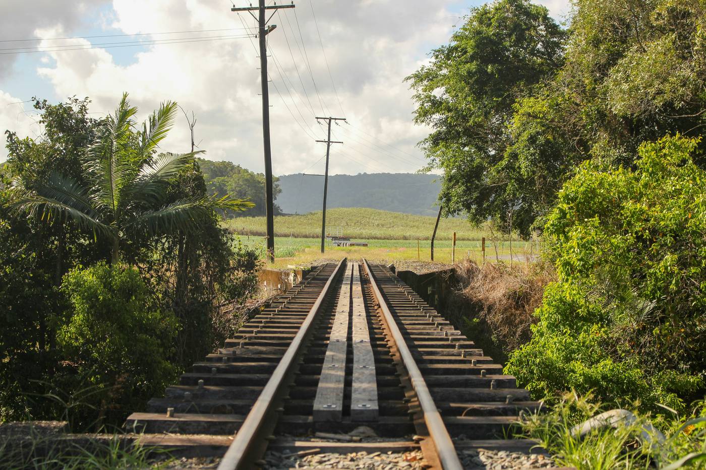 A single rail line running out through open farmland