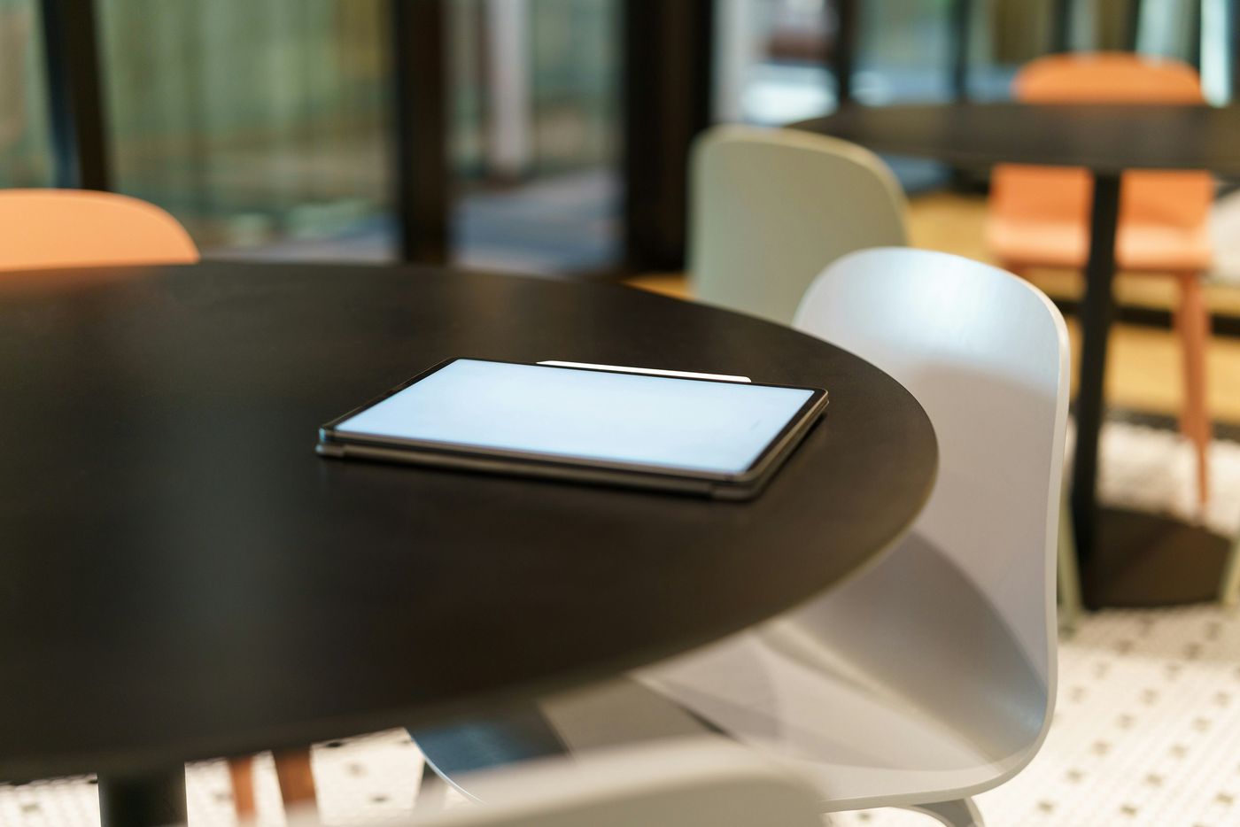 A tablet and notes left on a table before a morning meeting