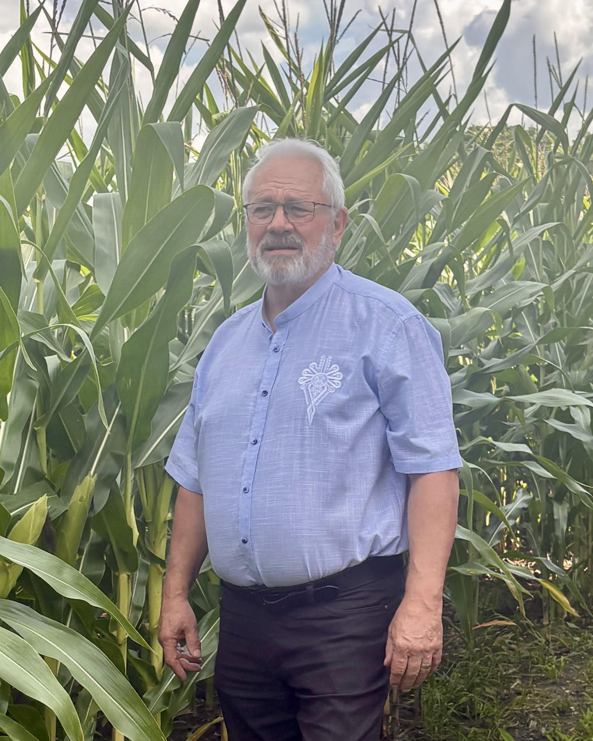 Tim J. Stanlick standing at the edge of a Thames Centre corn field